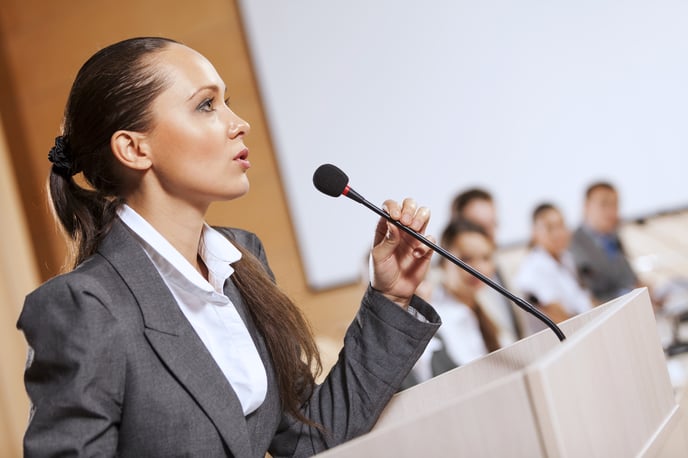 Businesswoman standing on stage and reporting for audience-2