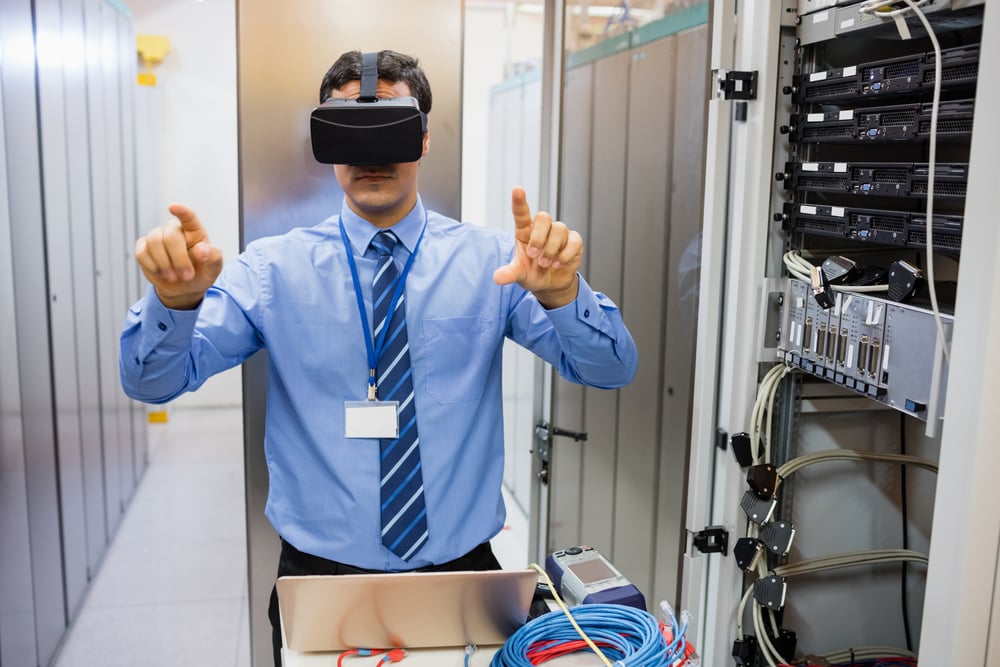 Technician using visual reality headset in server room